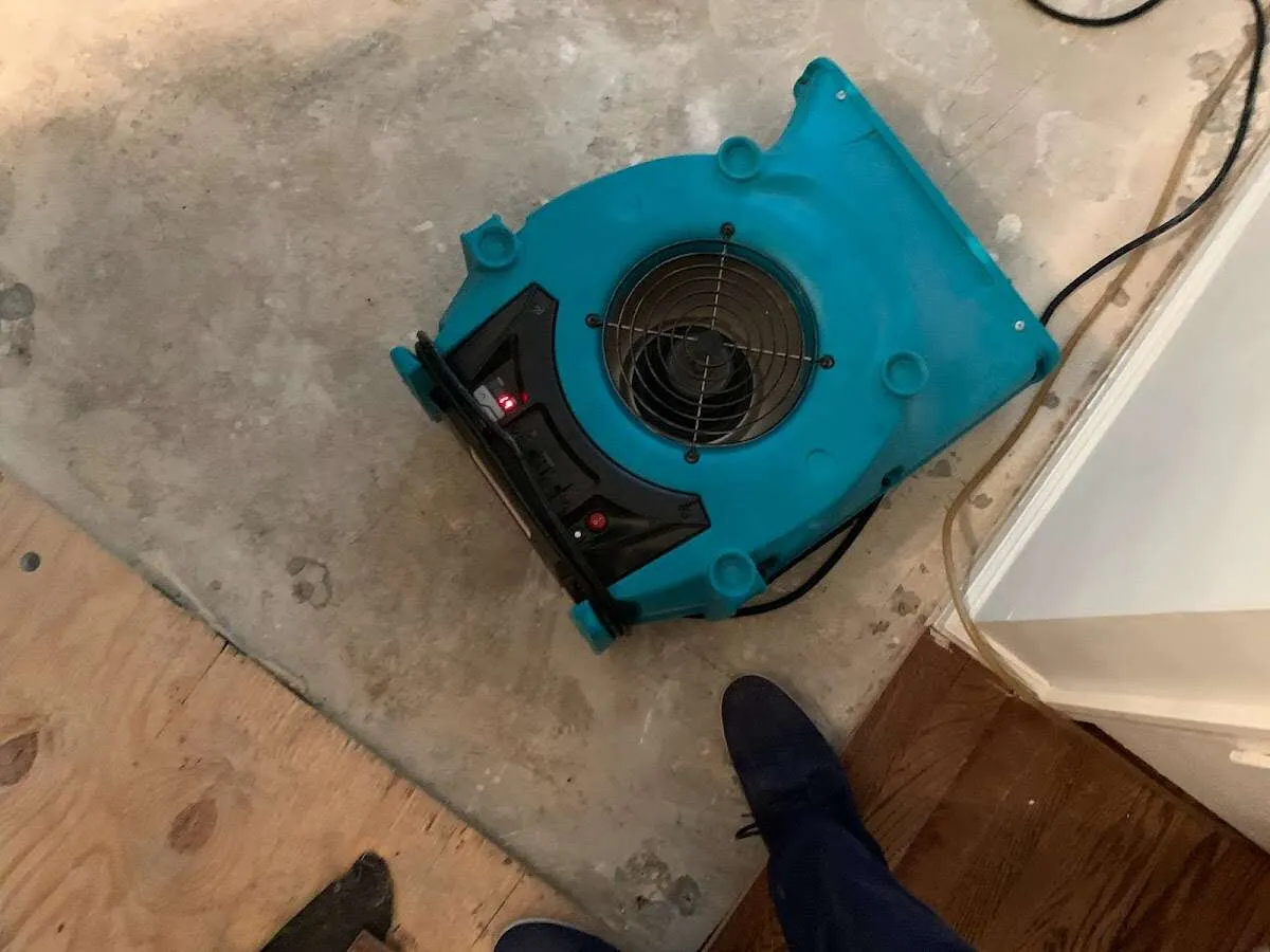 Air mover drying subfloor during Commercial Water Damage Restoration in Fort Myers